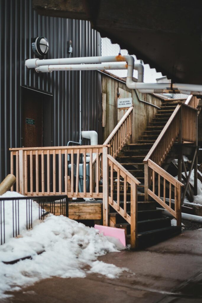 Wooden staircase in winter factory yard